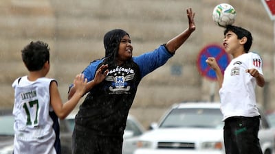 The rain couldn’t dampen the fun of these young boys yesterday, who took advantage of the day off school to play football. Delores Johnson / The National