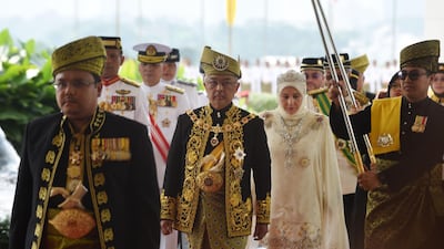 King Abdullah and Queen Tunku arrive for his royal coronation at the National Palace in Kuala Lumpur.