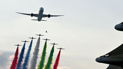 Aircrafts spray smoke in the colours of the United Arab Emirates flag over the grid of the Yas Marina Circuit before the start of the Abu Dhabi Formula One Grand Prix. AFP