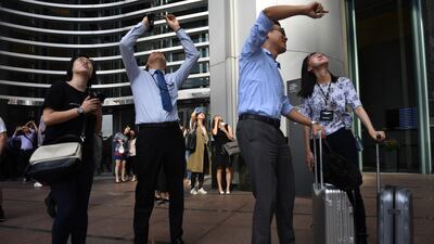 People watch as the French urban climber climbs the building. AFP