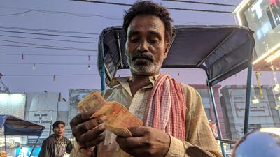 Ashok Mandal, 50, counting his earnings. Taniya Dutta for The National