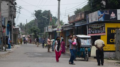 People walk along a street of a residential area during a government-imposed nationwide lockdown as a preventive measure against the Covid-19 coronavirus, in Siliguri. AFP