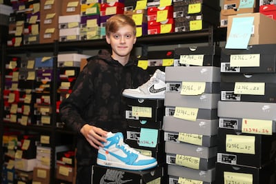 Harry Tomkinson shows off his stock of trainers at his family's villa in Arabian Ranches, Dubai. Pawan Singh / The National