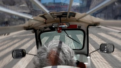 A man rides a tourist tuk-tuk along an empty street, amid the Covid-19 pandemic in Lisbon, Portugal. Reuters