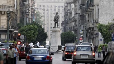 Cars pass through Talaat Harb Square in downtown Cairo, Egypt. Bloomberg