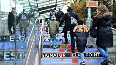 Children and their parents arrive at a vaccination centre in Vienna. AFP