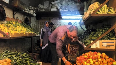 Sarah Al Hanbali, Jordan: Sarah captured this image of a fruits and vegetables merchant as he organises his shop in the local souq in Al-Salt city in Jordan.