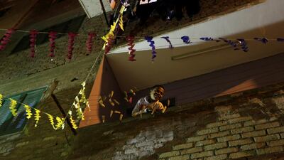 A boy looks from the balcony as Hajja Dalal beats a drum to wake up Muslims to have the predawn meal before they start their long-day fast during the holy month, at Maadi neighbourhood in Cairo, Egypt. Reuters