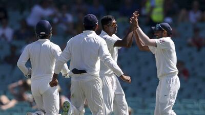 India's Ravichandran Ashwin, second right, celebrates with teammates after bowling Australia's Shane Watson for 16 runs on the fourth day of Test match in Sydney, Friday, Jan. 9, 2015. Rick Rycroft/AP Photo