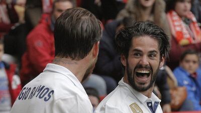 Real Madrid midfielder Isco, right, celebrates with his teammate Sergio Ramos after scoring his team's third goal against Sporting Gijon during their Spanish Primera Liga match at El Molinon Stadium in Gijon, northern Spain, 15 April 2017. Real Madrid won 3-2. Alberto Morante / EPA