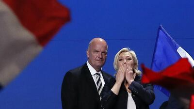 French far-right presidential candidate Marine Le Pen, flanked by her body guard Thierry Legier, blows kisses to supporters at the end of a rally in Villepinte, outside Paris, on May 1, 2017. Francois Mori / AP Photo