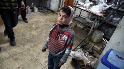 A wounded Syrian child stands at a makeshift hospital in the rebel-held area of Douma, east of the capital Damascus, as victims of several reported air strikes on the city are brought in by rescue teams on April 22. Abd Doumany / AFP