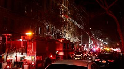 Firefighters respond to a building fire that killed at least 12 people in the Bronx borough of New York on December 28, 2017. Four survivors were in critical condition. Frank Franklin II / AP Photo