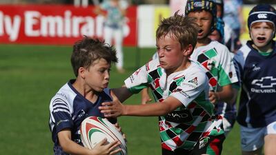 An Abu Dhabi Harlequin defender grabbled for a tackle to take down a Warrior player during their match in game action on Friday, January 22, 2016, at the HSBC Rugby Festival Dubai. DELORES JOHNSON / The National