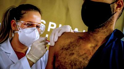 Health worker and volunteer Paulo Roberto Oliveira receives a Covid-19 vaccine produced by Chinese company Sinovac Biotech at the Sao Lucas Hospital, in Porto Alegre, southern Brazil. AFP