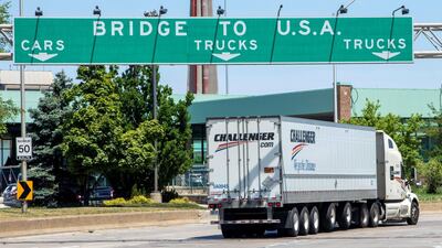 A truck heads towards the Ambassador Bridge, a main trade route linking Canada and the United States, as coronavirus disease (COVID-19) restrictions remain in place in Windsor, Ontario on Sunday. Reuters