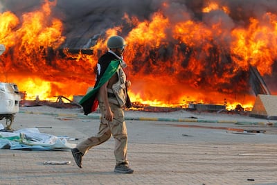A Libyan rebel walks through Qaddafi's Bab Al Aziziya compound in Tripoli after it was overrun in August 2011.