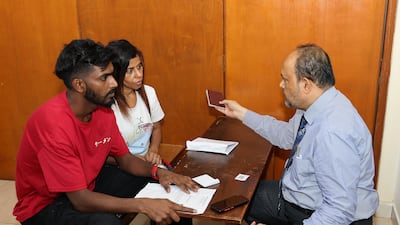 Sri Lankan consular officials guide people who have overstayed their visas.