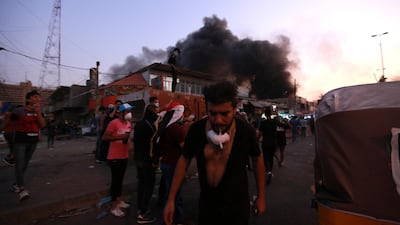 A man reacts to tear gas fired by security forces during ongoing during ongoing protests at Tahrir Square. AP Photo