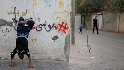 A Palestinian boy practises dancing in the Al Nusairat refugee camp, central Gaza Strip. AP Photo