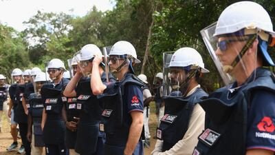 England players, from left to right, Jonny Bairstow, Keaton Jennings, Joe Root and Olly Stone fitted out with de-mining personal protective equipment listen to a briefing before a tour of a previously cleared area of mine in Periyamadu. Getty Images