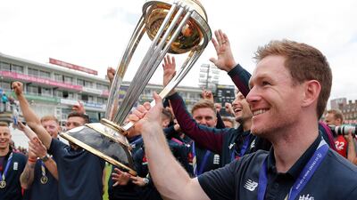 England's Eoin Morgan, right, and teammates celebrate with the trophy at the Oval in London, one day after they won the Cricket World Cup in a final match against New Zealand. AP Photo