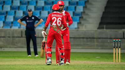 Oman batters in discussion during the game against Scotland. Photo: ICC