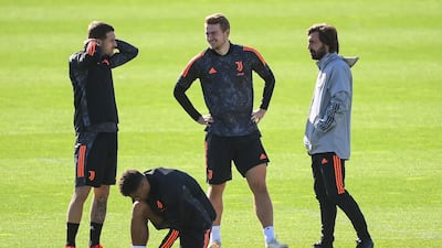 Juventus' Dutch defender Matthijs de Ligt, centre, and manager Andrea Pirlo, right, during the players' training session on the eve of the UEFA Champions League Group G match against Barcelona. AFP