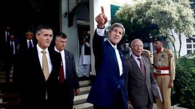 US secretary of state John Kerry leaves a press conference with Pakistan's foreign affairs advisor Sartaj Aziz, right, in Islamabad.