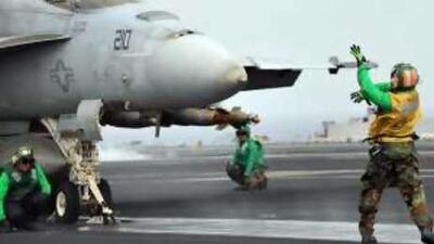 Deck crew on board USS Ronald Reagan prepare an F-18 for operations over Afghanistan.