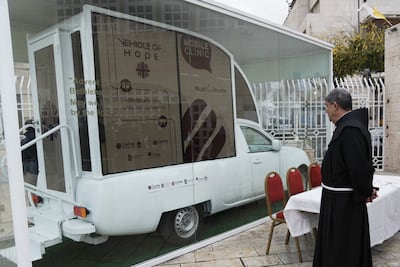 Father Ibrahim Faltas looks at the converted popemobile. AP