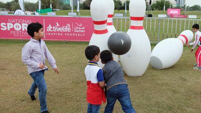 Among the activites held at Zayed Sports City was throwing an oversized inflated ball at large bowling pins. Delores Johnson / The National