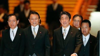 With Taro Aso, as deputy PM and finance minister, second left, Mr Abe has instilled "Abenomics" to nourish the country's slowing rate growth with an ageing population. EPA