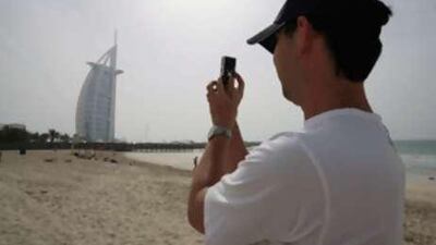 A tourist photographs the Burj Dubai; hoteliers say occupancy rates are down by a quarter.