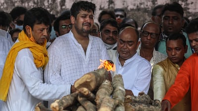 An emotional Bappa Lahiri performs rituals during the cremation in Mumbai. EPA