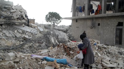 A survivor in the town of Jindayris, Aleppo province, tries to salvage items from the ruins after February's earthquake in Syria. Groups that supply humanitarian assistance to the quake zones say they are struggling despite western countries easing sanctions imposed upon Syria during the 12-year civil war. AFP