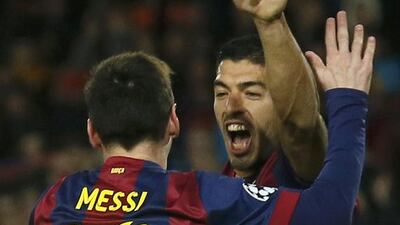 Barcelona's Lionel Messi, left, celebrates with teammate Luis Suarez after scoring a goal against Paris Saint-Germain during their Uefa Champions League Group F match at the Nou Camp stadium in Barcelona on December 10, 2014. Albert Gea / Reuters