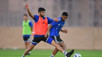 Mohammed Al Attas tackles Mohammed Juma during a UAE training session.