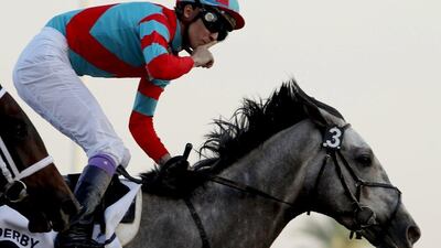 Japan's Yutaka Take (R) gestures after leading Lani to win the UAE derby during the Dubai World Cup horse racing event on March 26, 2016 at the Meydan racecourse in the United Arab Emirate of Dubai. / AFP / MARWAN NAAMANI