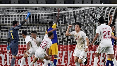 Al Wahda players celebrate after scoring a goal. AFP