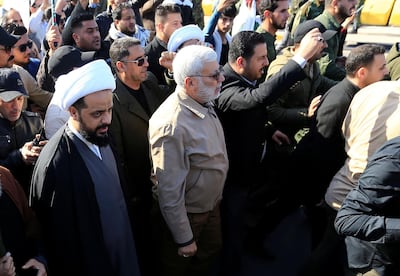 Qais Al Khazali, left, leader of the militant group Asaib Ahl Al Haq, and Abu Mahdi Al Muhandis, centre of the photo, a commander in the PMF, attend a funeral procession before the attack on the US embassy in Baghdad. Reuters