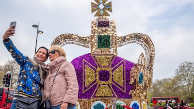 People take a selfie in front of a replica of the St Edward's Crown in London. Getty