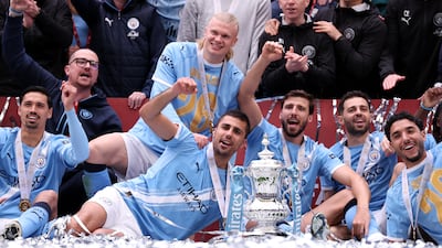 Manchester City players with the FA Cup trophy after defeating Chelsea in the final at the Wembley Stadium. Getty Images