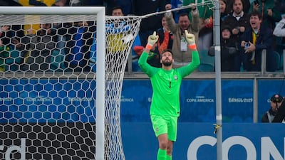 Alisson celebrates after stopping the shot by Paraguay's Gustavo Gomez in the penalty shoot-out. AFP