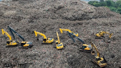 Rescuers use heavy machinery to search for people trapped by a landslide at Bantargebang landfill, in Indonesia. AFP