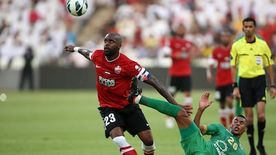 ABU DHABI , UNITED ARAB EMIRATES Ð May 28 , 2013 : Grafite ( no 23 red ) of Al Ahli and Hassan Ibrahim ( no 26 green ) of Al Shabab in action during the President Cup final match between Al Ahli vs Al Shabab at Mohammed Bin Zayed Stadium in Abu Dhabi. ( Pawan Singh / The National ) For Sports