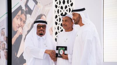 Sheikh Mohamed bin Zayed presents an award for Lt General Mohammad Hilal Al Kaabi on behalf of Armed Forces Officers Club and Hotel for participating in Sandooq Al Watan, during a Sea Palace barza. They are seen with Lt General Dhahi Khalfan Tamim, Chairman of the Board of Directors at Sandooq Al Watan. Ryan Carter for the Ministry of Presidential Affairs ---
