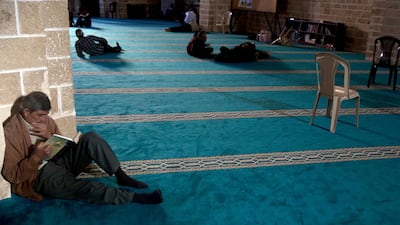 A Palestinian man reads verses of the Quran at Al Omari mosque in Gaza City. AP Photo