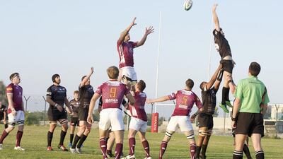 Abu Dhabi Saracens, in black, and Doha fight for possession during a West Asia Championship match in the capital on Friday night. Vidhyaa for The National