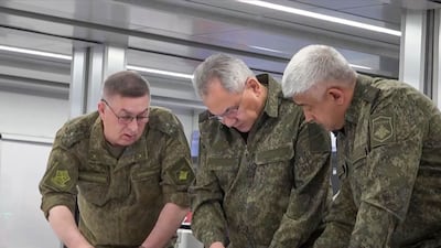 Sergey Shoigu, centre, was briefed on Russian combat operations. AFP